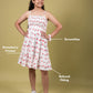 Girl wearing a strawberry printed dress with annotations on a beige background
