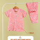 Pink floral pajama set with shirt and pants on a hanger against a beige background.