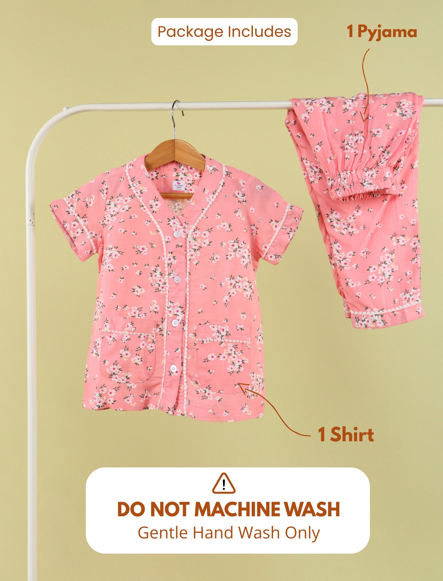 Pink floral pajama set with shirt and pants on a hanger against a beige background.