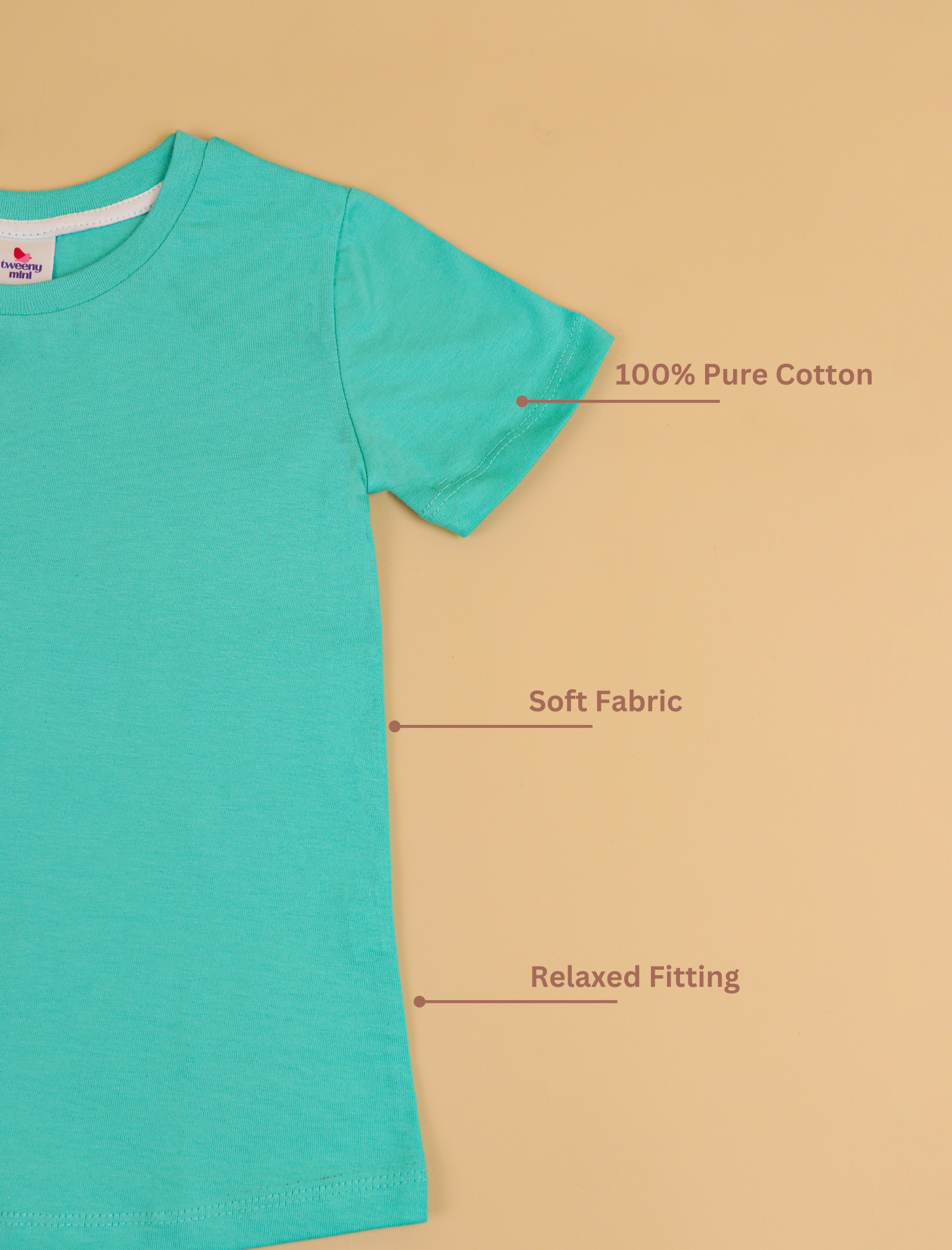 Turquoise t-shirt on a beige background with text indicating features like '100% Pure Cotton', 'Soft Fabric', and 'Relaxed Fitting'.