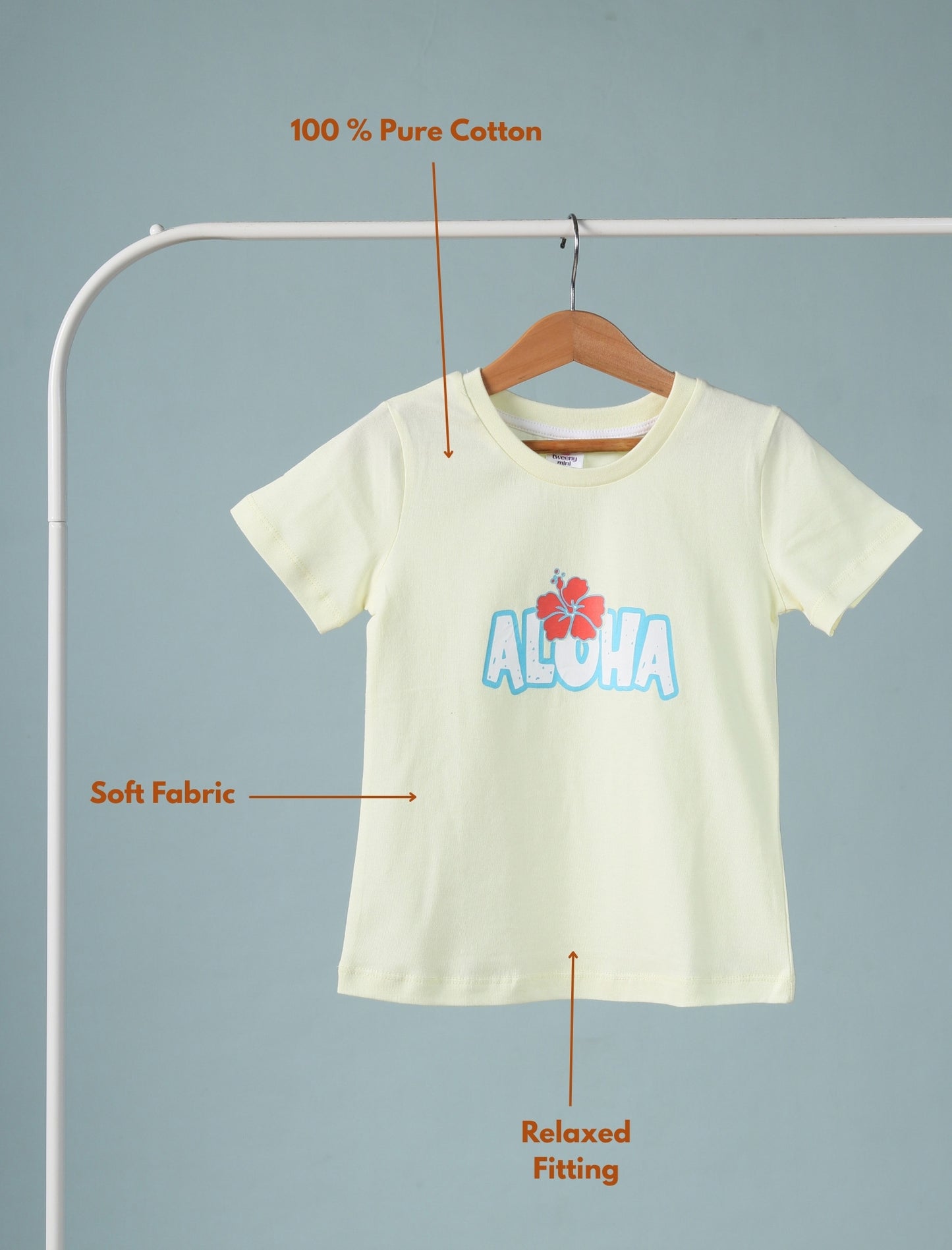 Lemon yellow t-shirt with 'Aloha' design on a hanger against a gray background