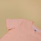 peach sleeveless top on a beige background