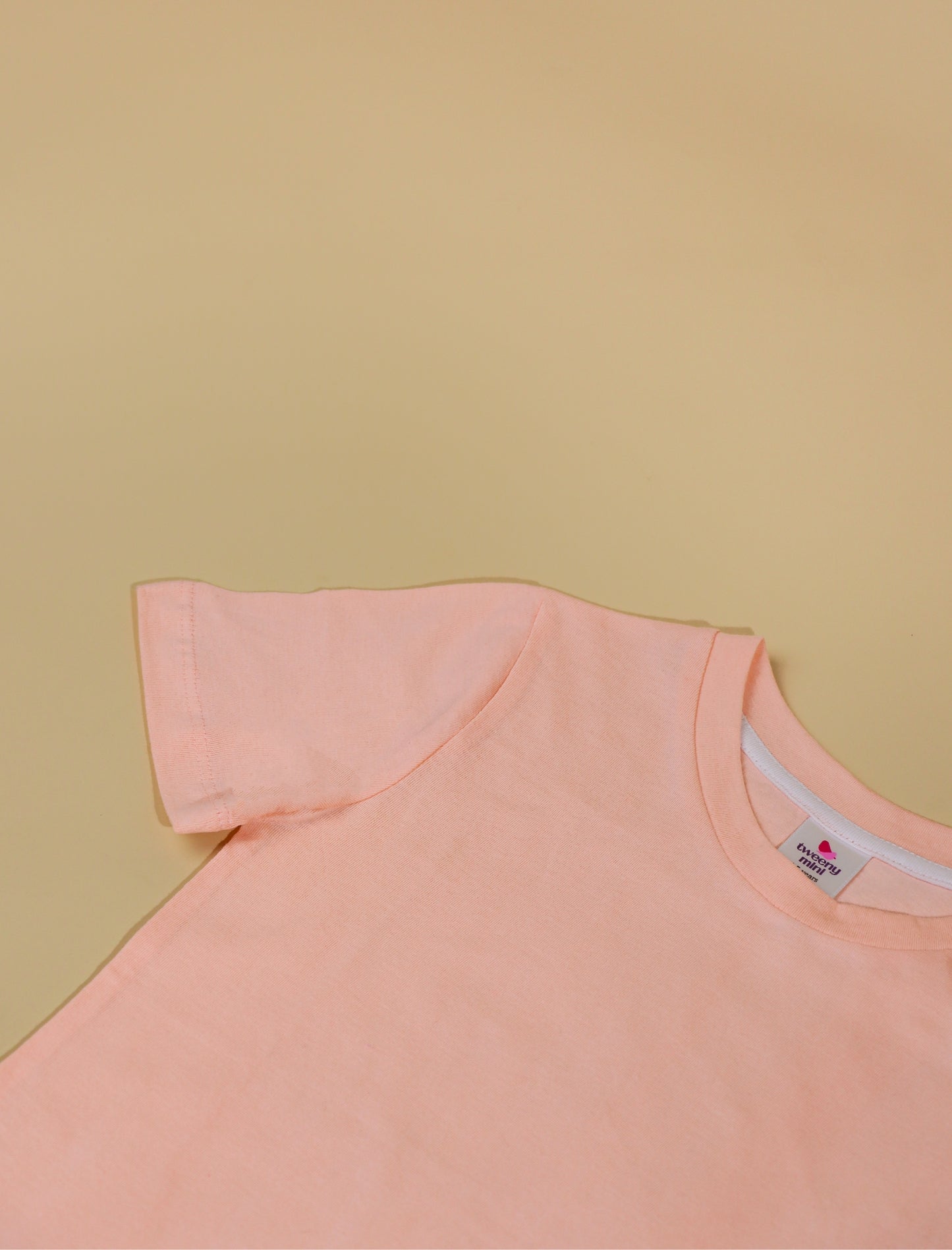 peach sleeveless top on a beige background