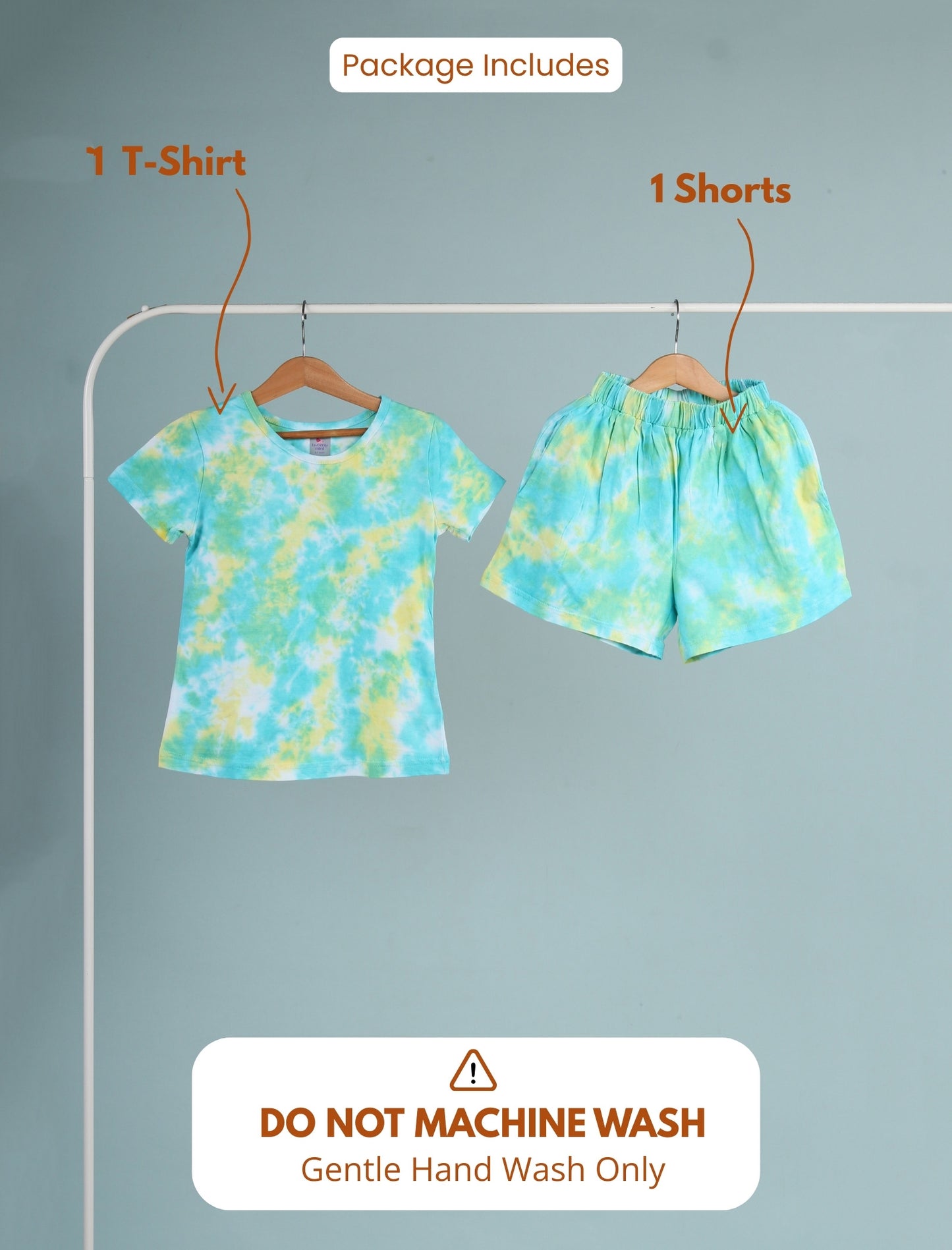Tie-dye t-shirt and shorts set on hangers with washing instructions on a gray background