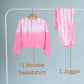 Pink tie-dye hoodie and jogger set on a rack against a gray background