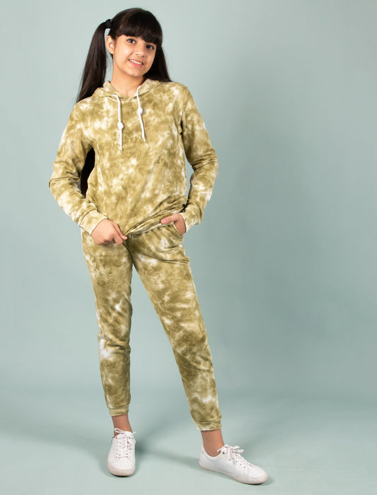 Girls wearing a green tie-dye hoodie and pants set on a gray background