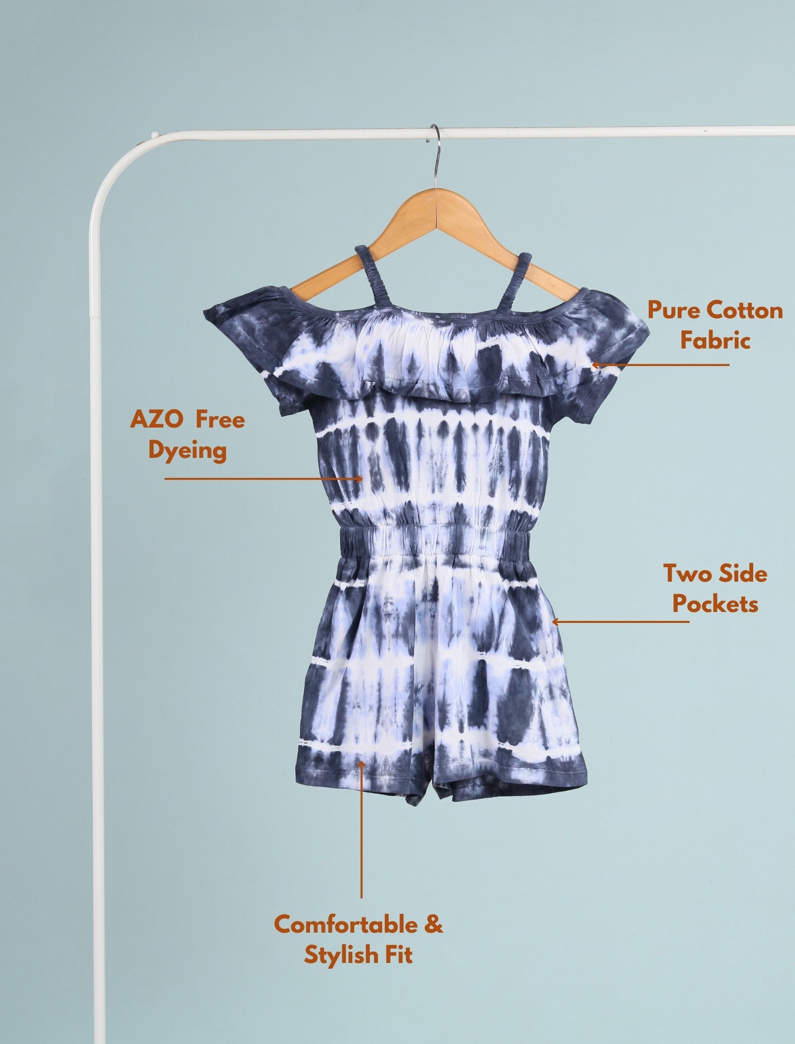 Tie-dye romper on a hanger with text highlighting features against a light blue background