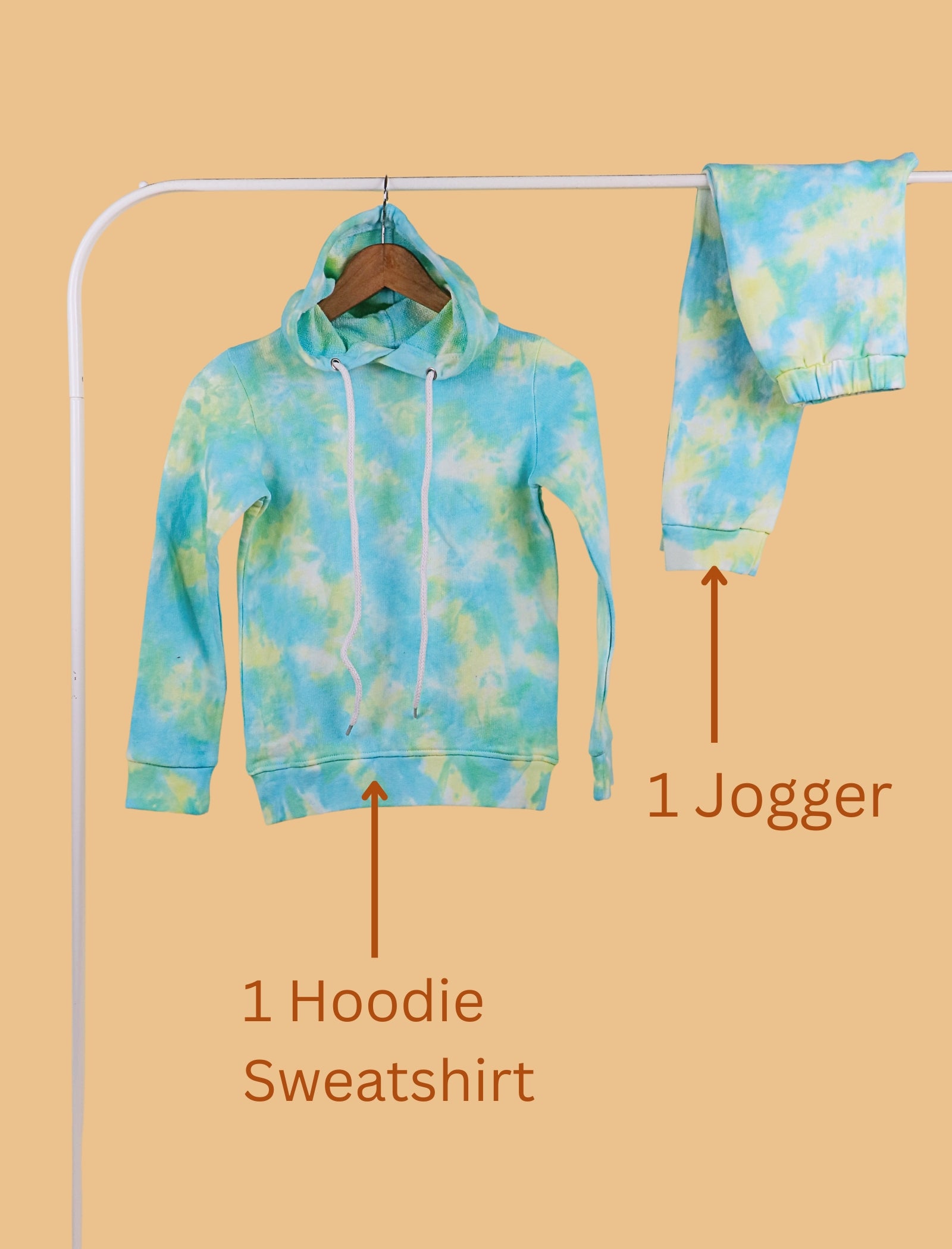 Blue tie-dye hoodie sweatshirt and jogger on a hanger against a beige background