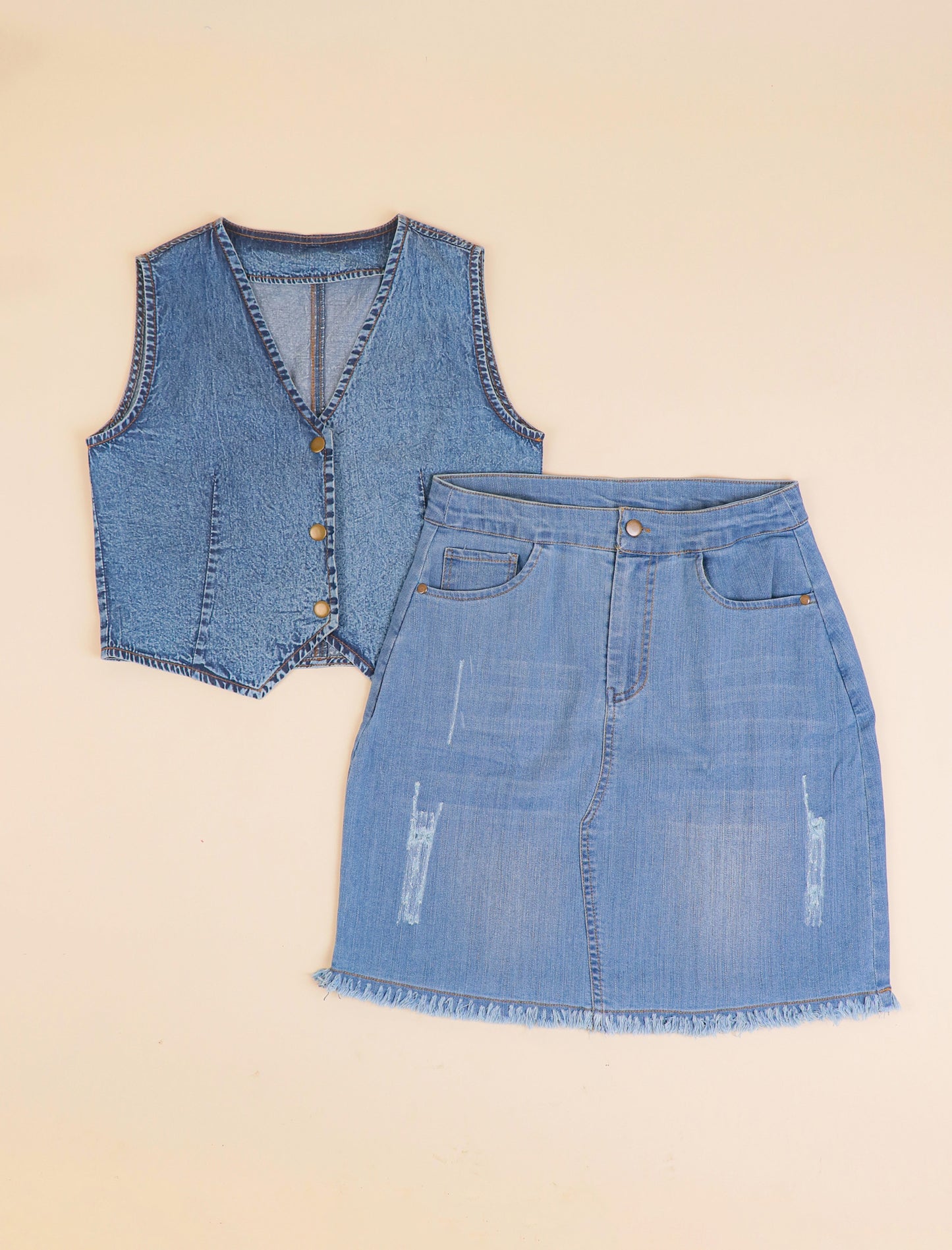 Denim vest and skirt set on a beige background