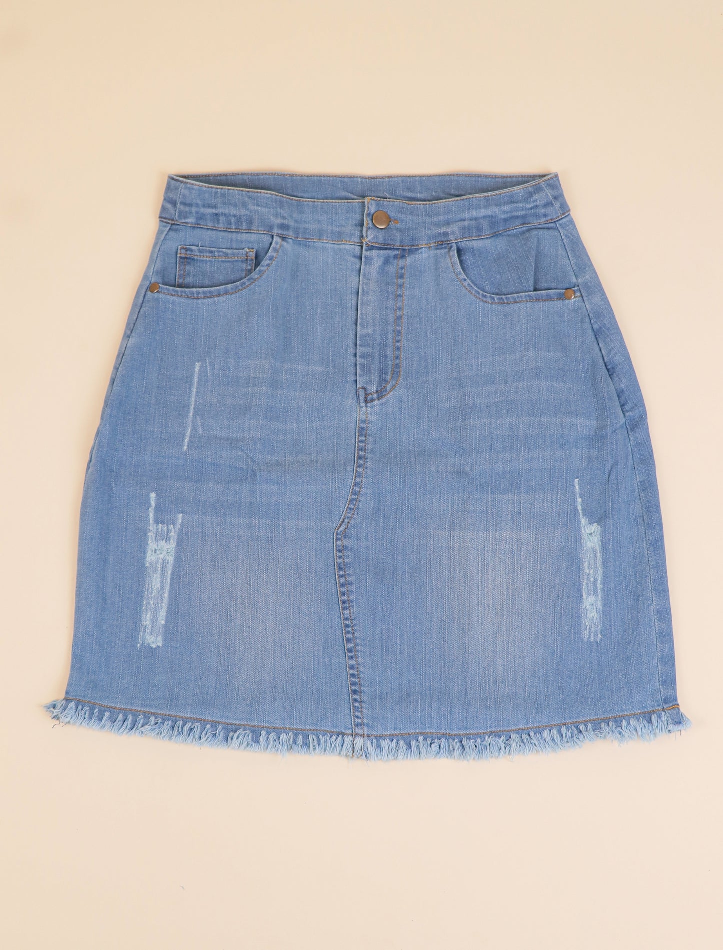 Blue denim skirt on a beige background