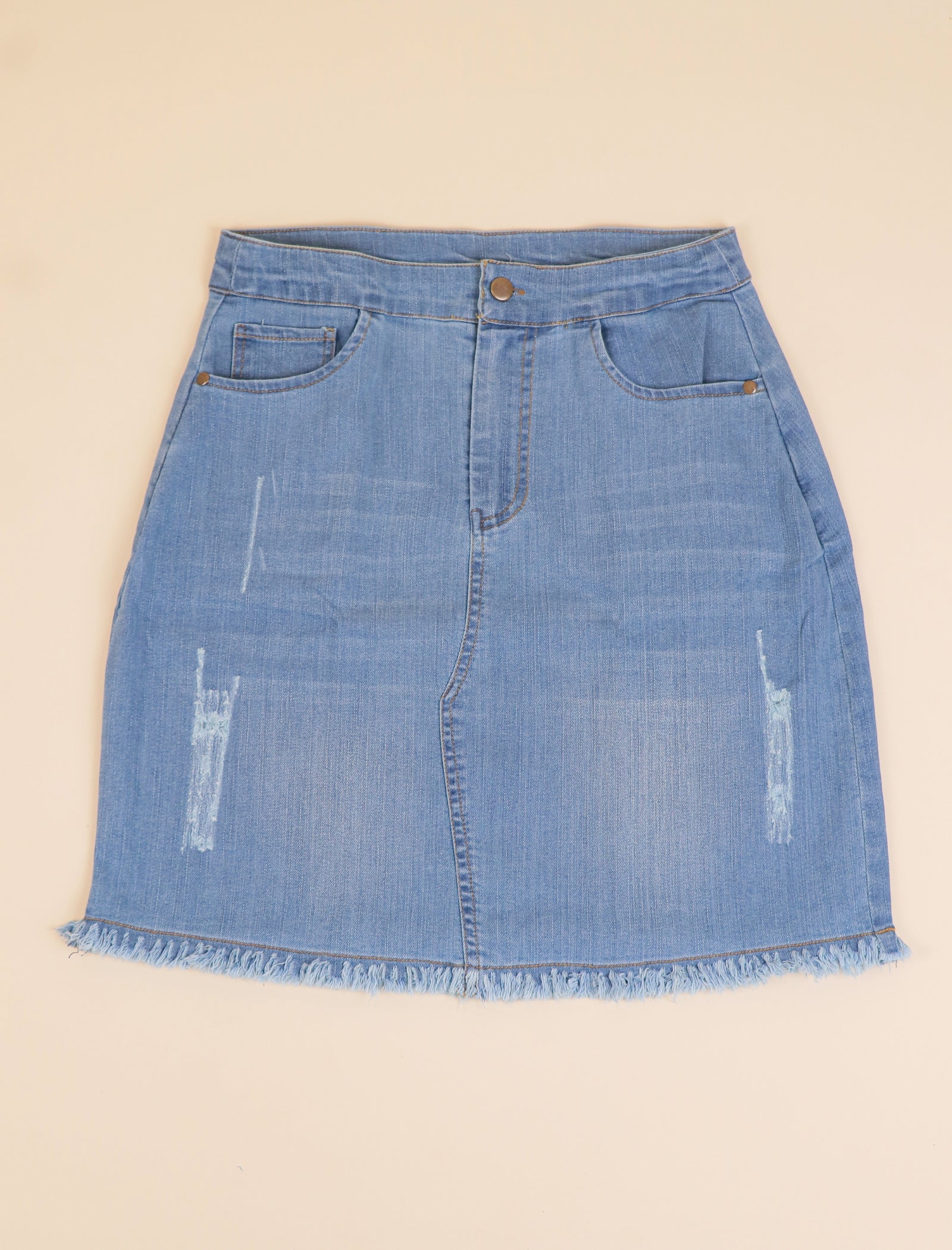 Blue denim skirt on a beige background