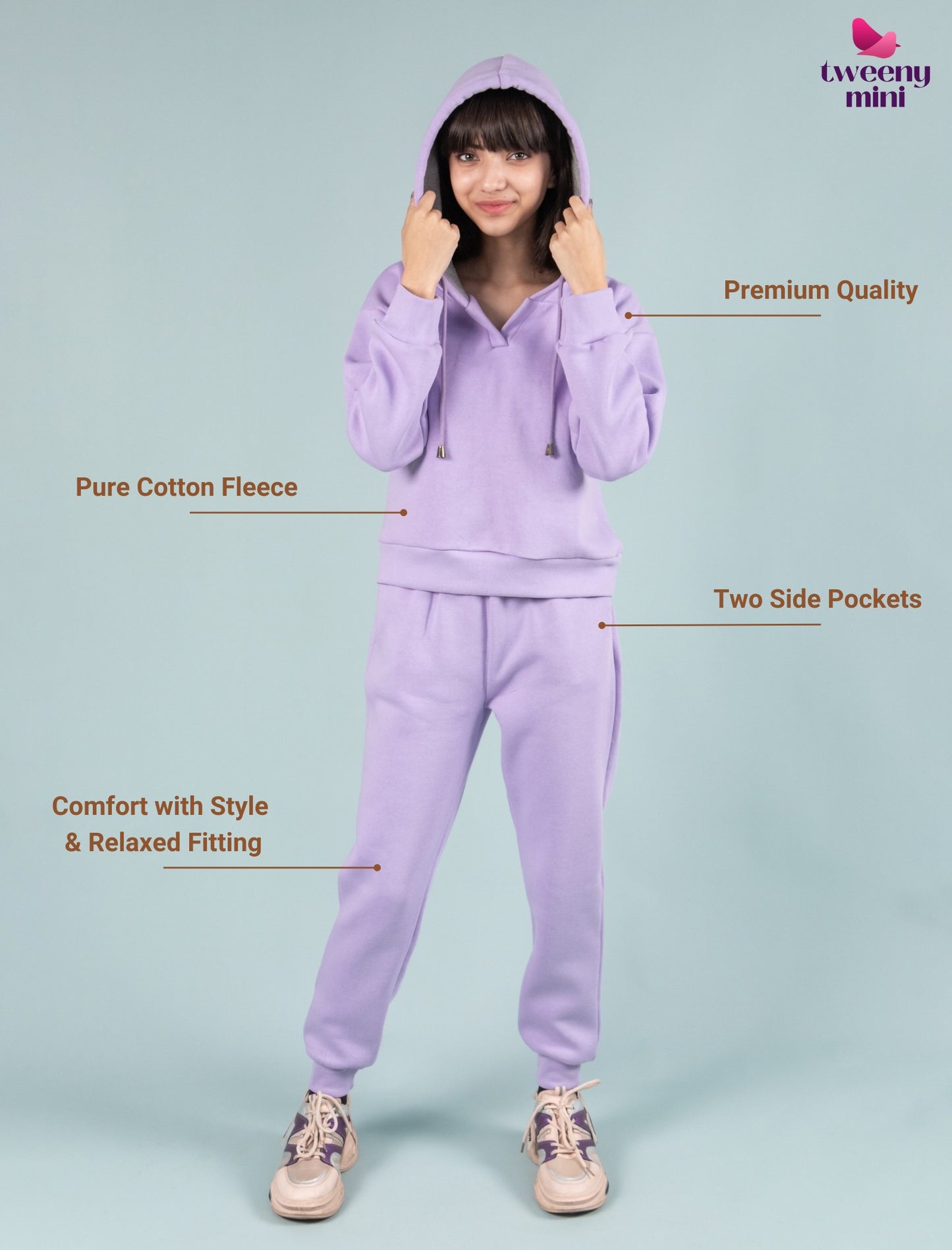 Girl wearing a purple hoodie and pants with text highlighting features on a light blue background
