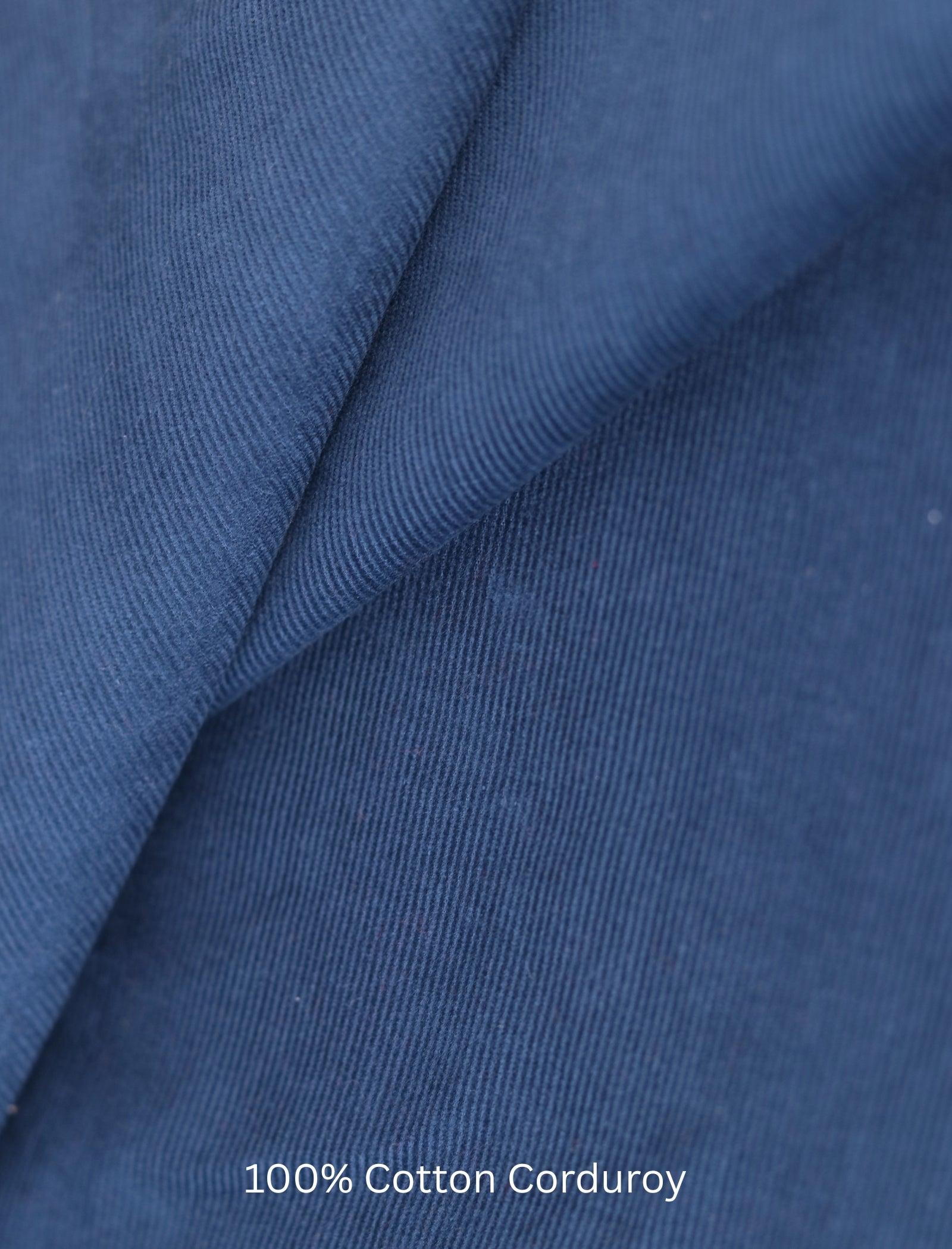 Close-up of blue 100% cotton corduroy fabric with text overlay.