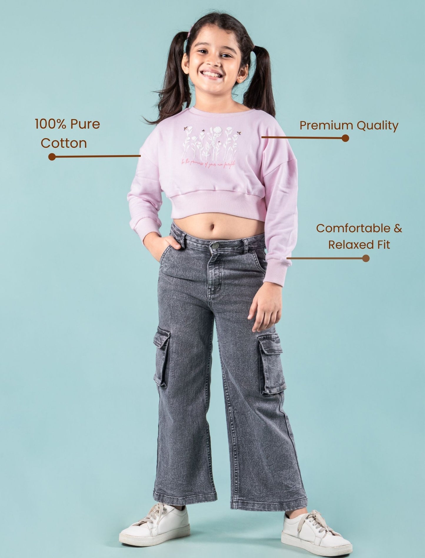 Girls wearing a pink winter sweatshirt and gray jeans with text highlighting features on a light blue background