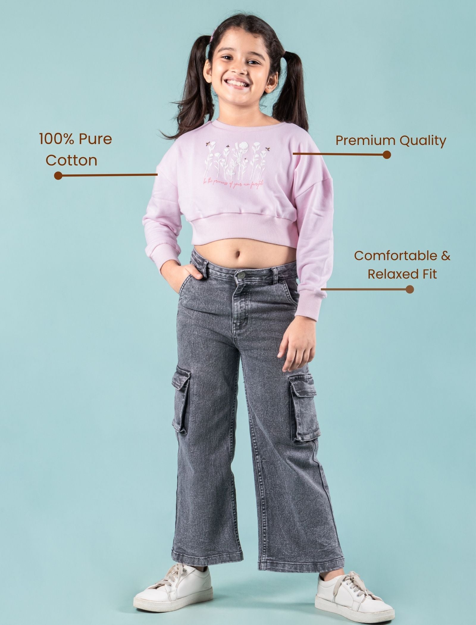 Girls wearing a pink winter sweatshirt and gray jeans with text highlighting features on a light blue background