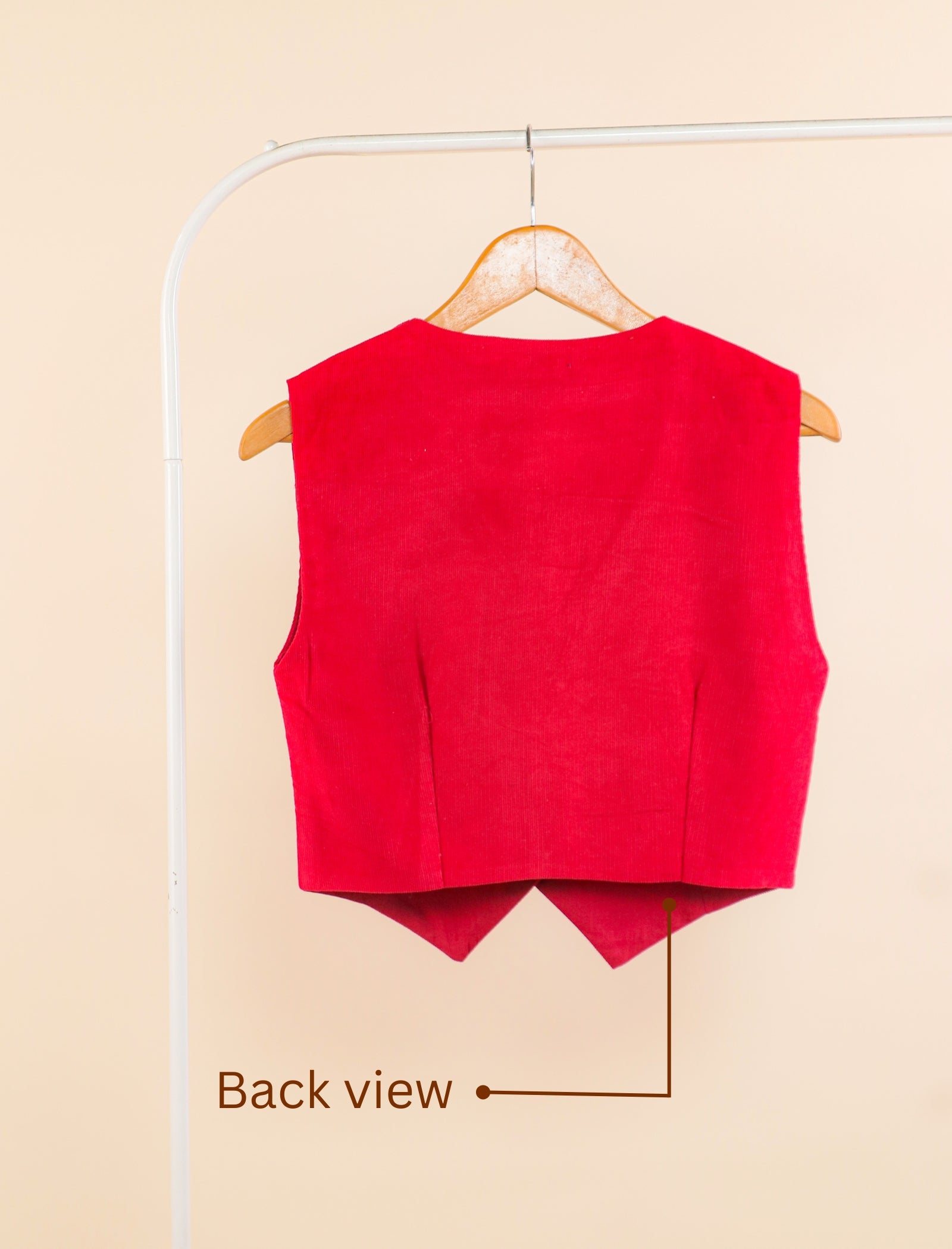 Red vest on a hanger with 'Back view' text on a beige background
