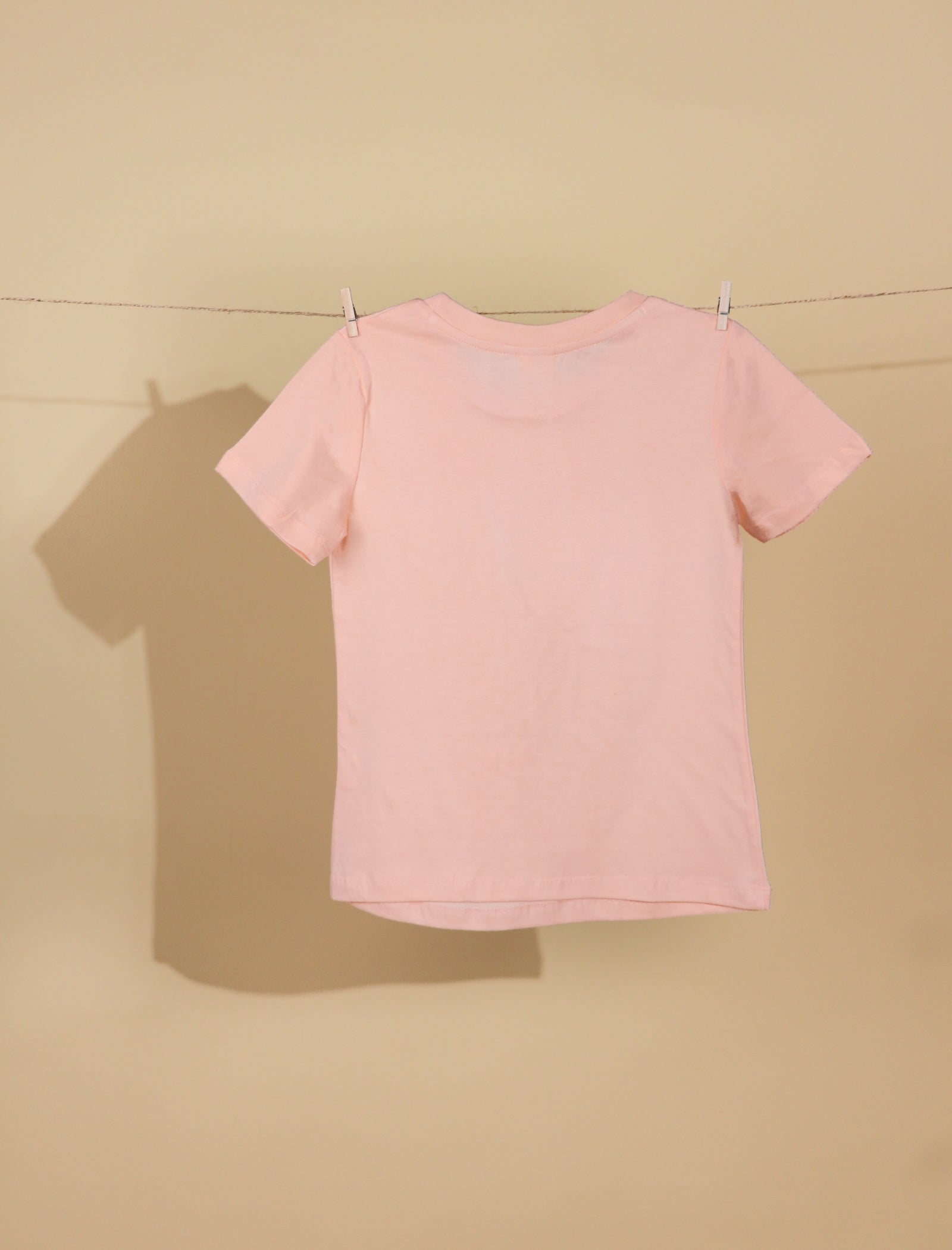 Peach t-shirt on a beige background
