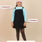 Girl wearing a light blue sweatshirt, black pinafore, and pink beanie with text indicating included items.