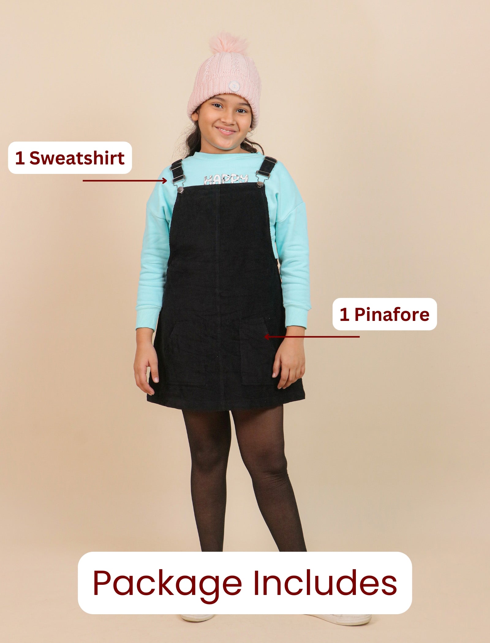 Girl wearing a light blue sweatshirt, black pinafore, and pink beanie with text indicating included items.